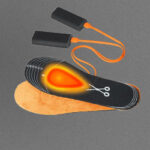 NordicHeat heating pads with connected battery pack, placed on a background. A heated section is marked on one sole.